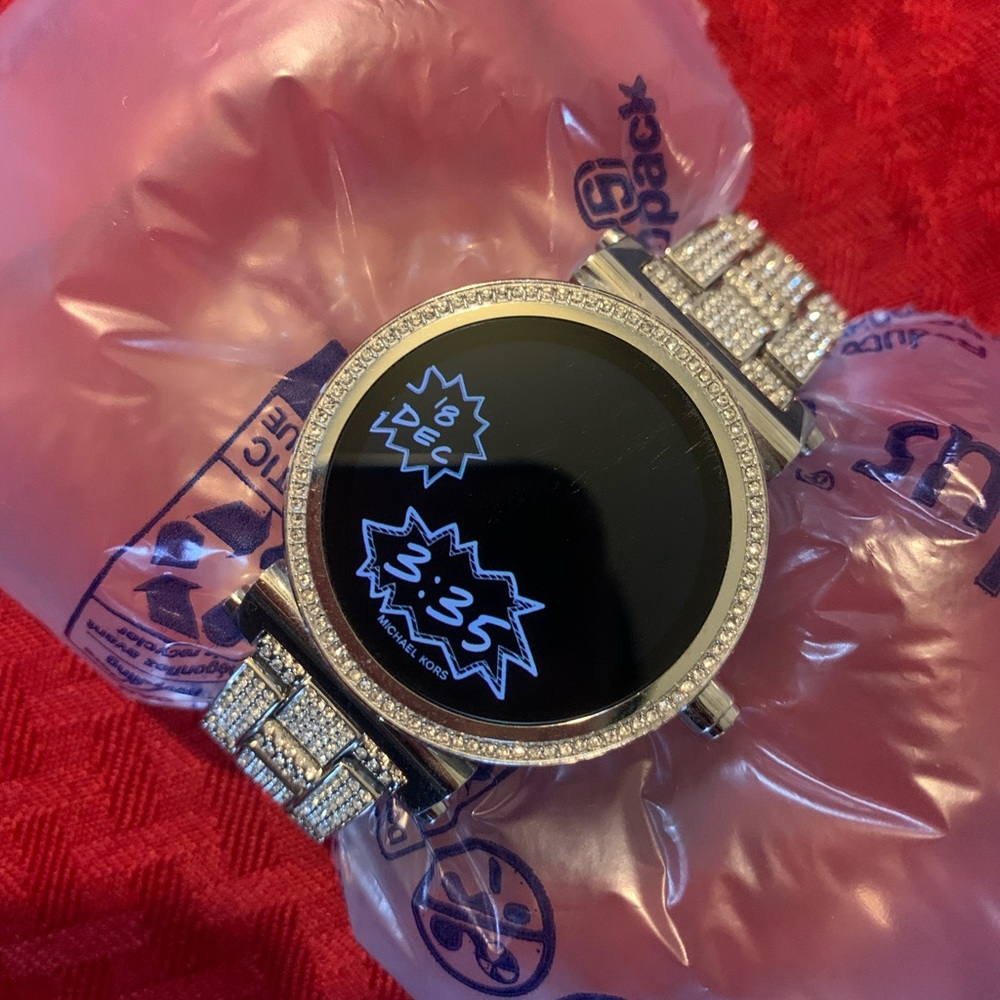 Beautiful Michael Kors smartwatch, has Diamond accents around watch band.